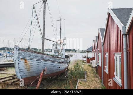 Old wooden ship on the bank of Wirksund pier in Denmark Stock Photo