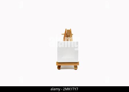 Small white easel with blank canvas isolated on a plain white background. Copy space. No people. Stock Photo