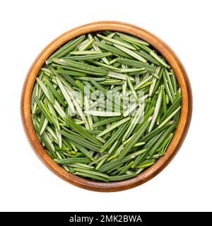 Fresh rosemary leaves, in a wooden bowl. Salvia rosmarinus, an aromatic and evergreen shrub, with fragrant and needle-like, green leaves. Stock Photo