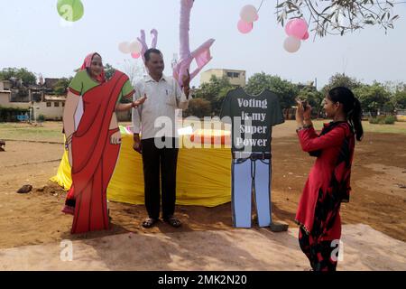 Indian voters pose for photographs after casting her vote at a