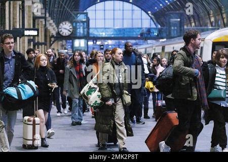 Revellers arrive London via King’s Cross rail station this afternoon ahead of New Year’s Eve firework celebrations in London tonight.   Image shot on Stock Photo