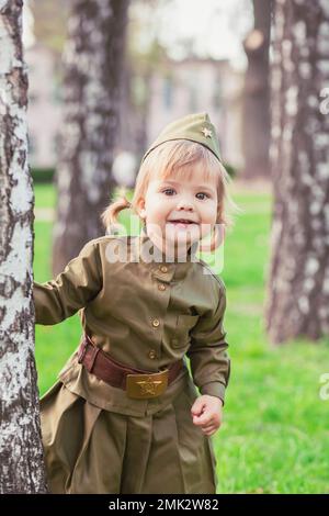 Adorable baby girl in Soviet military uniform Stock Photo