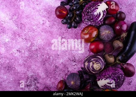 Assortment of purple vegetables on violet background Stock Photo