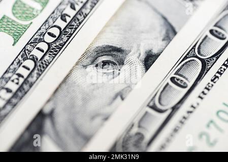 Benjamin Franklin's eyes from a hundred-dollar bill. 100 dollar bill Stock Photo