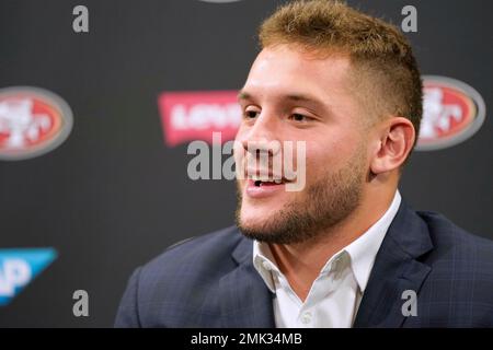 San Francisco 49ers first-round pick Nick Bosa, center, holds up a jersey  next to general manager John Lynch, left, and coach Kyle Shanahan, right,  during an NFL football news conference, Friday, April