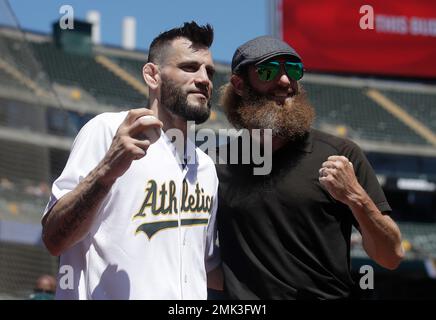 Former Oakland Athletics pitcher Dallas Braden wears a jersey of former San  Francisco Giants pitcher Tim Lincecum before a baseball game between the  Athletics and the Giants in Oakland, Calif., Friday, Aug.