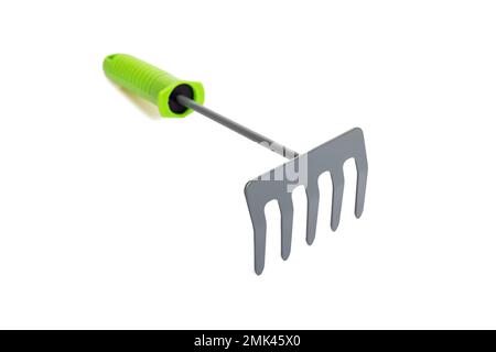 Small garden rake with green plastic handle isolated on a white background Stock Photo