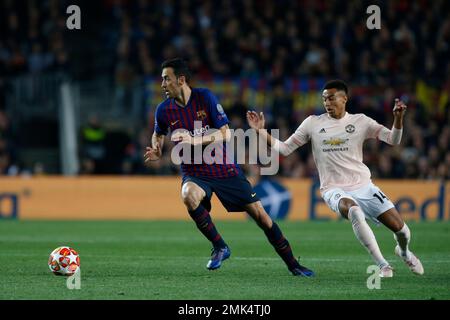 Barcelona midfielder Sergio Busquets heads the ball over AC Milan  midfielder Kevin Prince Boateng, of Ghana, during a Champions League first  leg quarterfinals soccer match, between AC Milan and Barcelona, at the