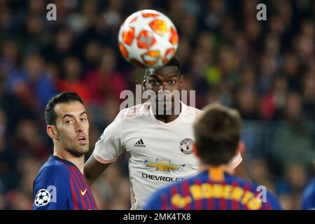 Barcelona midfielder Sergio Busquets heads the ball over AC Milan  midfielder Kevin Prince Boateng, of Ghana, during a Champions League first  leg quarterfinals soccer match, between AC Milan and Barcelona, at the