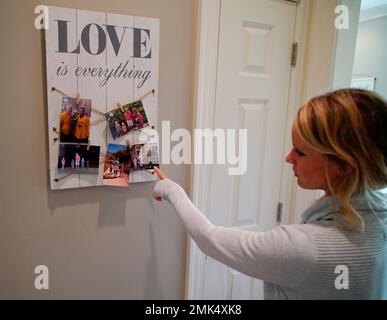 Kacey Ruegsegger Johnson looks at a photo of her family in a galley ...