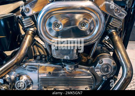 Fragment of v-twin engine in old-fashioned chopper. Chrome motor housing. Stock Photo