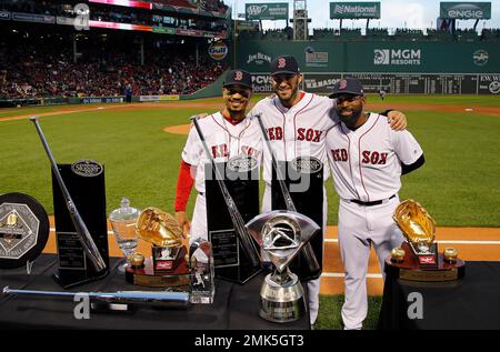 Boston Red Sox's Mookie Betts, left, J.D. Martinez, center, and Jackie  Bradley Jr. stand with their various 2018 awards including Silver Sluggers,  Gold Gloves and the AL MVP before a baseball game