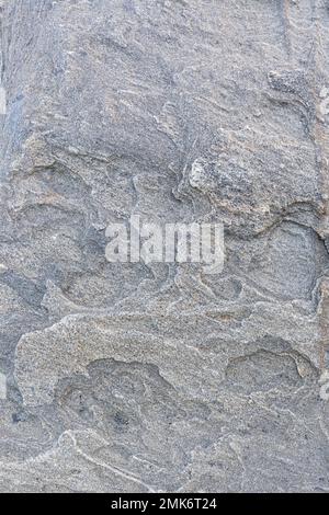 Close-up of a strange and beautiful rock surface, front view. Abstract full frame natural textured background. Stock Photo