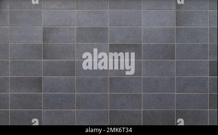 Front view of a wall made of gray slabs. Abstract full frame background of a new and modern wall or building exterior made of grey slabs. Stock Photo