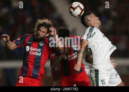 Gustavo Gomez of Brazil's Palmeiras heads the ball challenged by Carlos  Carmona of Chile's Colo Colo, right, during a quarter final second leg Copa Libertadores  soccer match in Sao Paulo, Brazil, Wednesday