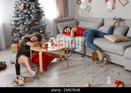 Drunk women sleeping in messy room after New Year party Stock Photo