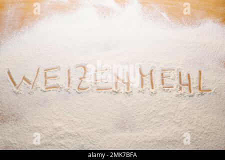 The word wheat flour was written in flour on a pasta board Stock Photo