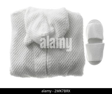 Clean folded bathrobe and slippers isolated on white, top view Stock Photo