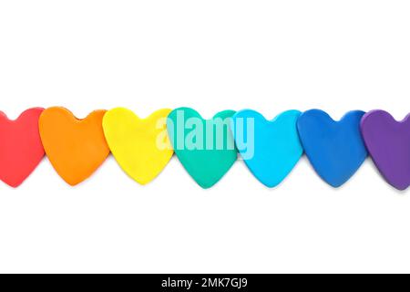 Colorful hearts made of modeling clay on white background, top view. Rainbow palette Stock Photo