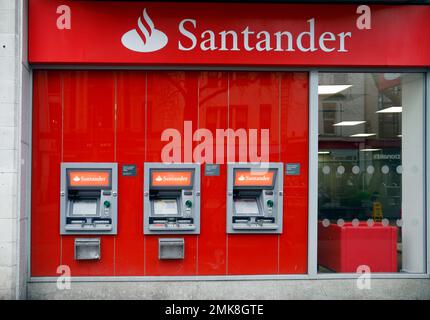 Santander bank frontage and three ATM machines. Queen Street, Cardiff, South Wales. January 2023. Winter. Stock Photo