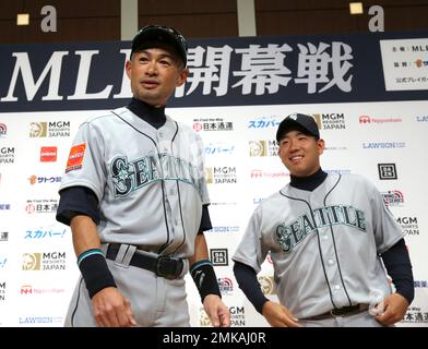 Seattle Mariners' Yusei Kikuchi (L) and Ichiro Suzuki talk during