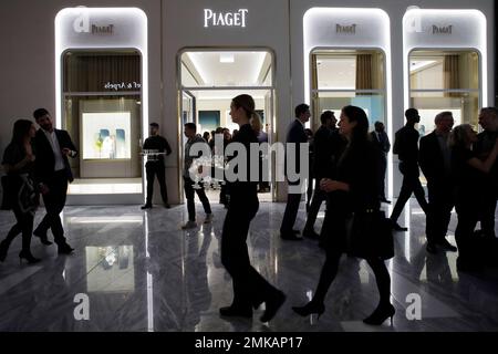 People attend the opening of a Piaget store during the opening