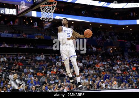 Duke's RJ Barrett (5) goes up for a dunk on a break away in front of  Pittsburgh's Malik Ellison (3) during the second half of an NCAA college  basketball game, Tuesday, Jan.