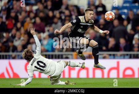 Real midfielder Luka Modric left tries to stop Ajax s Dusan Tadic during the Champions League round of 16 second leg soccer match between Real Madrid and Ajax at the Santiago Bernabeu stadium