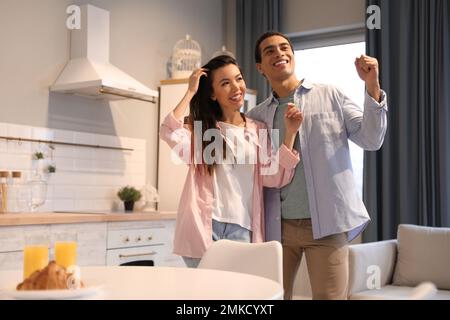 Lovely young interracial couple dancing at home Stock Photo