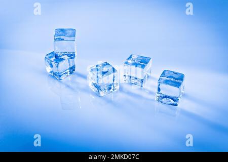 Cold ice cubes on a reflective surface Stock Photo