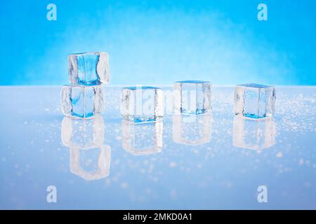 Cold ice cubes on reflective surface with water drops Stock Photo - Alamy