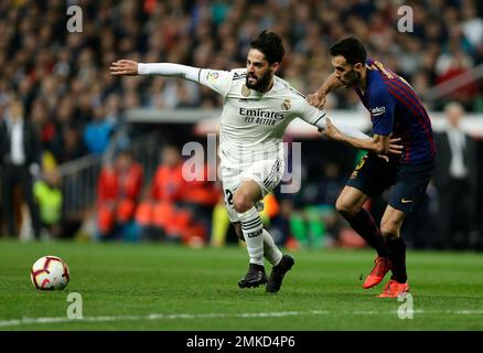 Barcelona midfielder Sergio Busquets heads the ball over AC Milan  midfielder Kevin Prince Boateng, of Ghana, during a Champions League first  leg quarterfinals soccer match, between AC Milan and Barcelona, at the