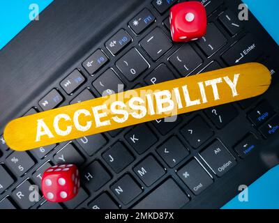 Red dice and keyboard with the word ACCESSIBILITY. Business concept. Stock Photo