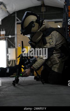 Staff Sgt. Raul “Adrian” Ayala, an explosive ordnance disposal technician assigned to the 380th Expeditionary Civil Engineer Squadron, sets up a laser pointer and a Percussion Actuated Neutralizer tool during an x-ray challenge September 8, 2022, at Al Dhafra Air Base, United Arab Emirates. By using a grid and x-ray imaging in tandem, EOD technicians can precisely target key components of explosive circuits without setting them off. Stock Photo