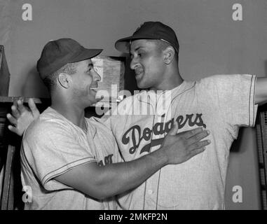 Moose Skowron, right, first baseman of the New York Yankees, jokes with Roy  Campanella about his muscles after the Brooklyn Dodger catcher won the pre- game hitting contest at Ebbets Field, Brooklyn, New