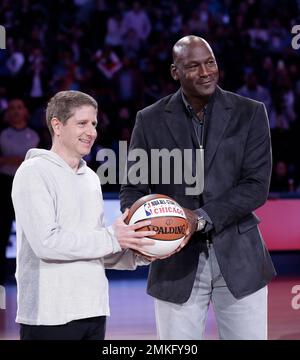 Michael Reinsdorf president and COO of the Chicago Bulls receives a basketball from Charlotte Hornets Owner Michael Jordan during the second half of an NBA All Star basketball game Sunday Feb. 17 2019...