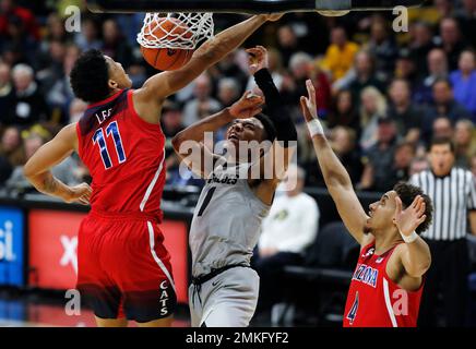 Colorado guard Tyler Bey, center, loses control of the ball after UC Irvine  guard Evan Leonard, right, attempted a steal as UC Irvine forward Tommy  Rutherford covers in the first half of