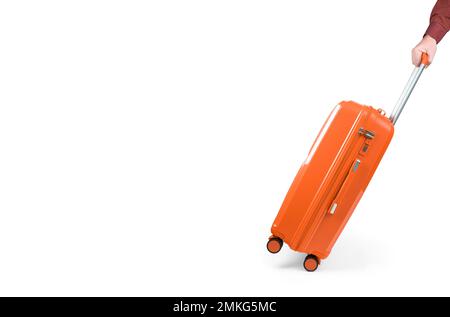 hand holds orange suitcase on white background. large plastic baggage case, luggage trolley bag, summer holidays, tourism, vacation Stock Photo