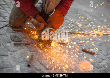 Angular grinding machine cuts metal with sparks Stock Photo