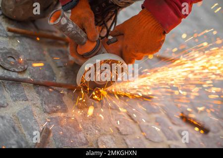 Angular grinding machine cuts metal with sparks Stock Photo