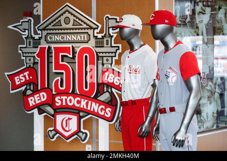 The Cincinnati Reds baseball team uniforms for the 2019 season are  displayed at Great American Ball Park, Monday, Jan. 7, 2019, in Cincinnati.  The Reds will play games in 15 sets of throwback uniforms, including navy  blue and a Palm Beach style