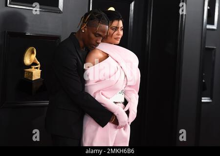 Kylie Jenner, left, and Travis Scott walks to their seats during the second  half in Game 2 of a first-round NBA basketball playoff series between the  Houston Rockets and the Minnesota Timberwolves