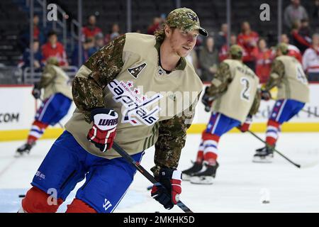Washington Capitals center Nicklas Backstrom (19), of Sweden, wears a  camouflage jersey and cap as part of military night during warmups before  an NHL hockey game against the Colorado Avalanche, Thursday, Feb.