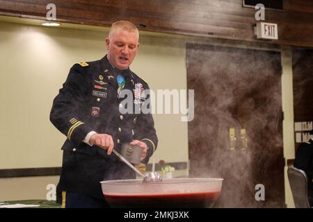 Capt. Martin Delaney, provost marshal of 2nd Stryker Brigade Combat Team, 4th Infantry Division, samples the ceremonial punch during a dining in at Ft. Carson, Colo., Sept. 9.  The brigade held the dining in to celebrate its past, build a more cohesive team, and provide a social atmosphere for camaraderie and fun.  U.S. Army photo by Maj. Jason Elmore. Stock Photo