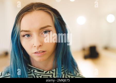 Image of caucasian female hip hop dancer posing to camera. Dance, rhythm, movement and training concept. Stock Photo