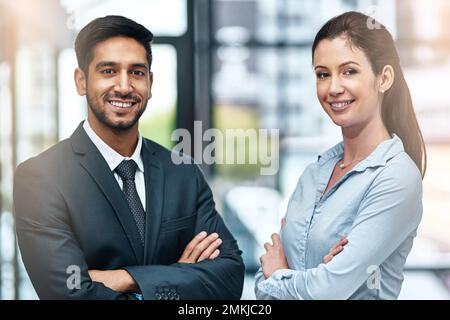 We have a reputation for doing good work. two businesspeople standing side by side. Stock Photo