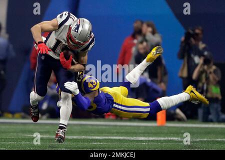 New England Patriots' Julian Edelman (11) breaks a tackle by Los Angeles  Rams' John Johnson III (43), during the second half of the NFL Super Bowl 53  football game Sunday, Feb. 3