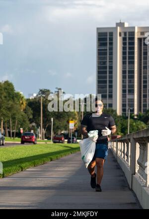 U.S. Navy Petty Officer 1st Class Ryan Delapuente, an information systems technician assigned to Joint Communications Support Element, clears debris along Bayshore Boulevard at Tampa, Florida, Sept. 9, 2022. Servicemembers volunteer monthly to maintain the roadway as part of the Petty Officer’s Association. Delapuente said that with each assignment, he has prioritized getting involved in the local community. He remarked how welcoming Tampa has been and shared his excitement to give back in future volunteer events. Stock Photo