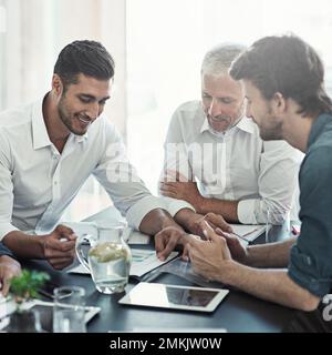 Great ideas in the making. a group of businessmen having a meeting around a table in an office. Stock Photo