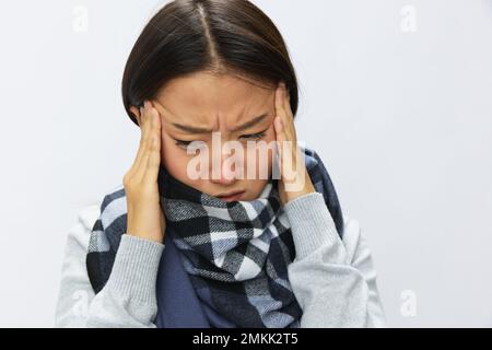 Asian woman cold flu raised hands from headache with fever sick from virus on white background, copy space Stock Photo